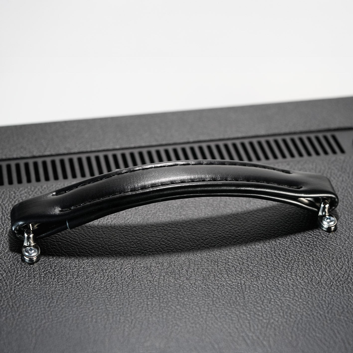 Close-up of Leviathan amplifier leather handle on top panel